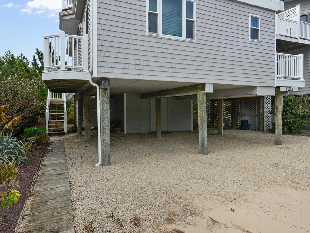 A two-story house with a covered patio area.