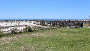 A wooden boardwalk leading to a beach with clear skies. - Couples Coastal Retreat 1min walk to the beach! (Gulf Shores)
