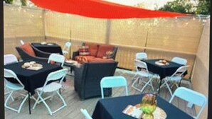 An outdoor patio area with tables and chairs, a sofa, and a small fire pit. - THE GEORGIA ROSE - A southern charm, with lots of character! (Atlanta)