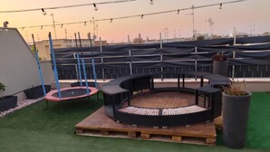 A rooftop terrace with a circular seating area, a trampoline, and a green artificial turf. - Elena's house, is a dream retreat for every type of guest (Sannicandro di Bari)