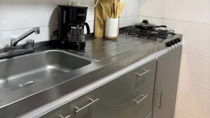 A modern kitchen with stainless steel appliances, a double sink, and grey cabinets. - Hermoso alojamiento centro (Cartagena)