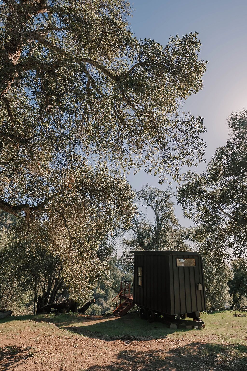A small, single-story structure with a flat roof, surrounded by trees.
