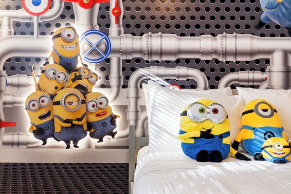 A bed with pillows shaped like minions, a metal grate, and a pegboard wall with various items. - Elegant Modern Townhome with Themed Bedrooms Close to Clubhouse (Kissimmee)