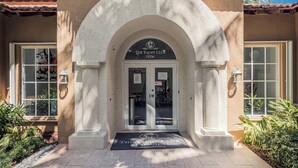 A building entrance with a stone archway, a sign reading "The Yacht Club Gym", and a doormat. - Stylish 2BR/2BA Getaway - Pool, Tennis Court & Free Parking (Aventura)