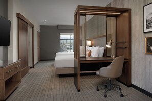 A hotel room with a bed, desk, chair, TV, and a large window. - Springhill Suites By Marriott Steamboat Springs (Steamboat Springs)