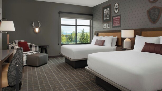 A hotel room with two beds, a desk, a chair, and a window with a view. - Towneplace Suites By Marriott Steamboat Springs (Steamboat Springs)