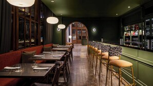 A restaurant with booths, high-top tables, and a bar area. - Humano, Lima, A Tribute Portfolio Hotel (Lima)