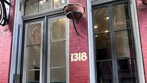 A red brick building with a black door and windows, numbered 1318. - Richmond City Skyline View with free parking (Richmond)