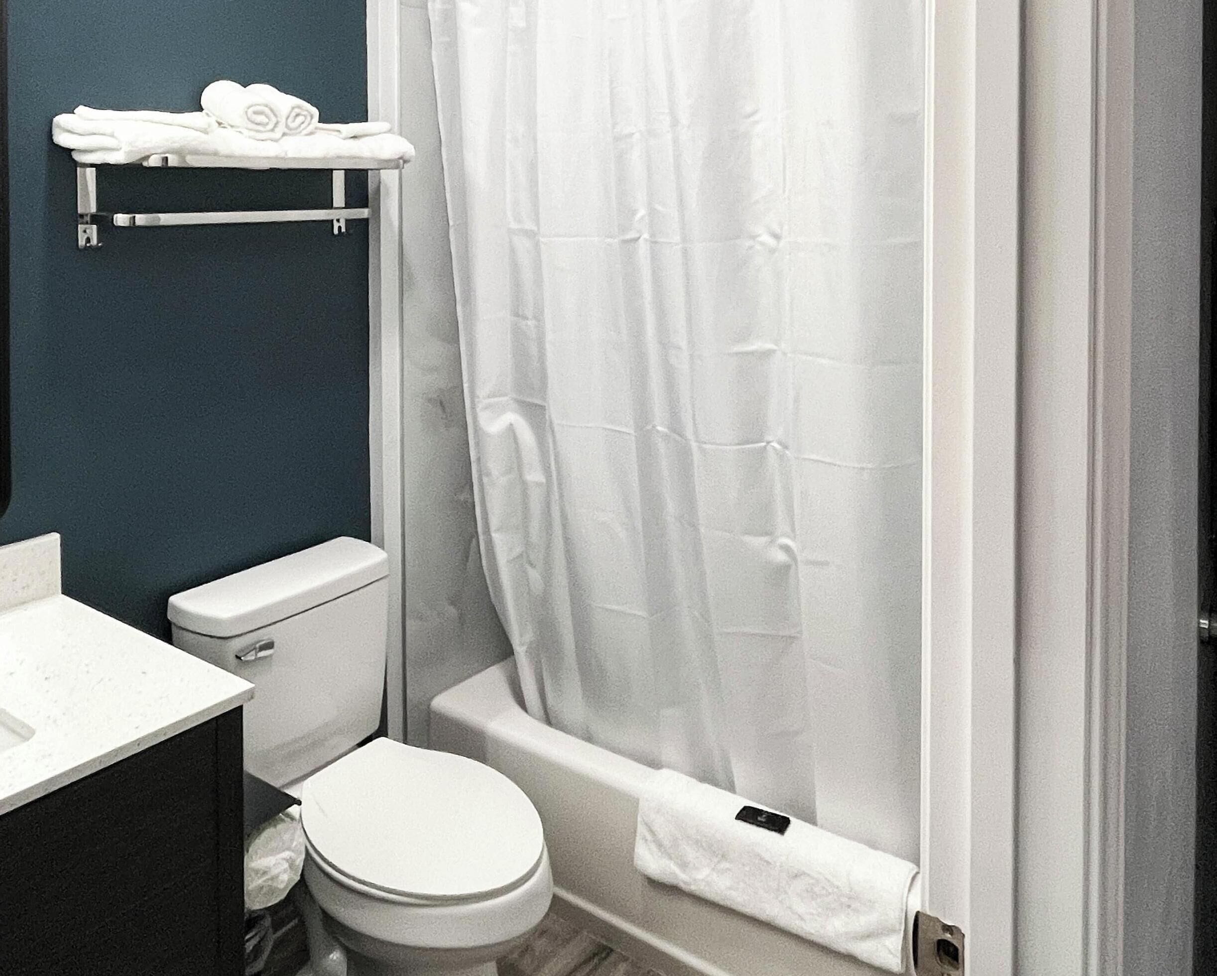 A bathroom with a toilet, sink, and bathtub.