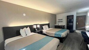 A hotel room with two beds, a desk, a chair, a microwave, and a refrigerator. - Studio 6 – Mobile, AL (Mobile)