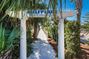 A pathway leading to a private beach area, marked by a signboard. - Gulf Place Caribbean 406 (Santa Rosa Beach)
