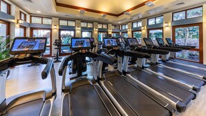 A gym with treadmills, ellipticals, and exercise bikes, large windows, and a modern ceiling design. - Marriott's Ko Olina Beach Club-2 Bedroom Unit-Mountain View-Full Resort Access (Kapolei)