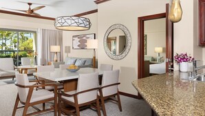 A modern hotel room with a dining area, a kitchen counter, and a large mirror. - Marriott's Ko Olina Beach Club-2 Bedroom Unit-Mountain View-Full Resort Access (Kapolei)