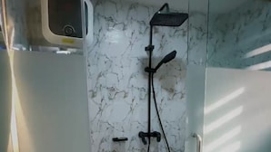 A bathroom with a glass shower enclosure, a sink, and a toilet. - A few steps away from the famous acropolis park, located in the heart of Apo! (Federal Capital Territory, Nigeria)