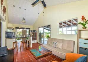 A spacious living area with a sofa, coffee table, and kitchen area with a microwave and toaster. - Paradera Breeze - 2-BR Vacation Home (Paradera)