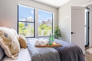 Dark green walls and large windows frame this bedroom, which opens directly to a private outdoor area, a rare escape when the group gets loud - Fall getaway near Belmont & Hillsboro Village, Nashville, sleeps 12 (Nashville)