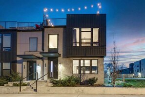 A modern two-story residential building with a balcony, large windows, and a visible number '516'. - Nashville summer getaway: rooftop deck, game room, 4br sleeps 12 (Nashville)