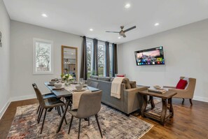 Gather the whole group in one open living and dining room, designed so everyone stays connected whether you're pre-gaming, eating, or settling in for a movie in Nashville - 4-bedroom Nashville townhome sleeps 12 near Centennial Park & Parthenon (Nashville)