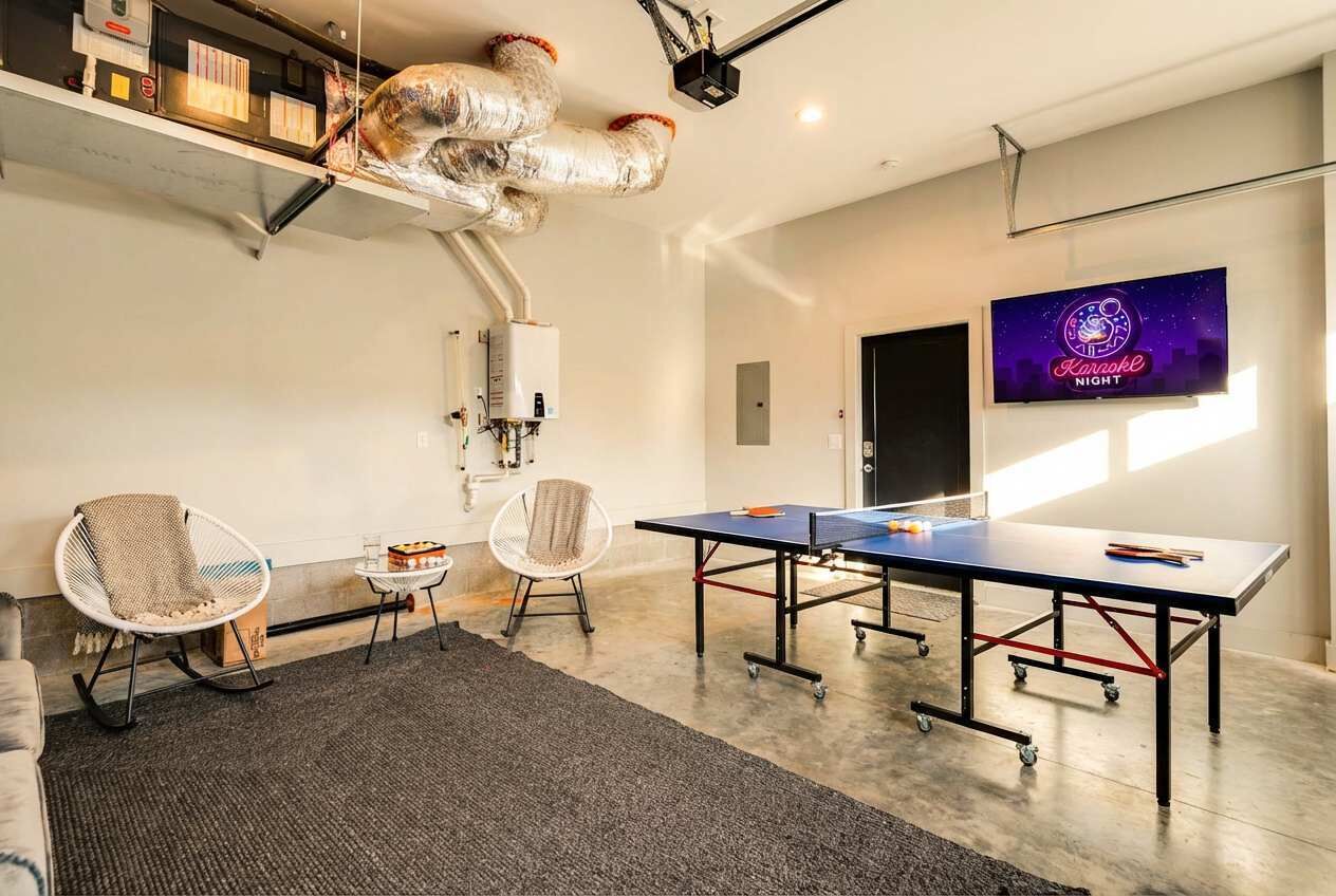 A modern conference room with a ping pong table, two chairs, a projector, and a neon sign.