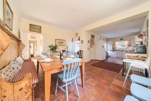 A spacious kitchen with a dining area, wooden furniture, and a tiled floor. - Eton House - sleeps 8 guests  in 4 bedrooms (Docking)