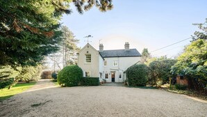 A two-story house with a gravel driveway leading to a front door. - Eton House - sleeps 8 guests  in 4 bedrooms (Docking)