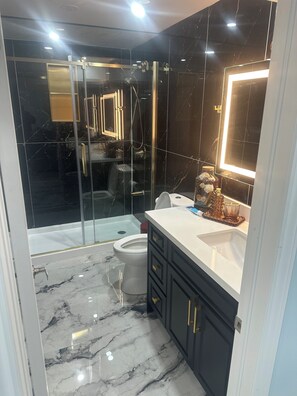 Shower, towels, soap, toilet paper