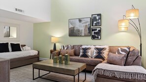 A modern living room with a sofa, a coffee table, and a lamp. - Treetops 4904 by Avantstay Hilton Head Condo + Balcony + Shared Pool + Tennis Court + Near Beach and Dining (Hilton Head Island)