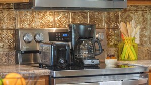 A kitchen with a coffee maker, toaster, and a stainless steel oven. - The Charming Retreat For 6! (Branson West)