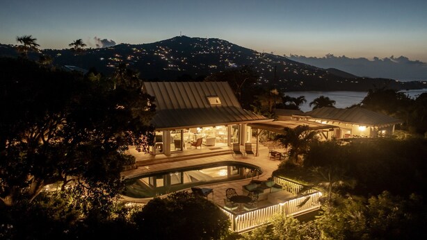 A luxurious villa with a swimming pool, outdoor seating, and a mountain backdrop. - Yellowbird Villa, Pool, Ocean Views, 6 bed, Luxury (St. Thomas)