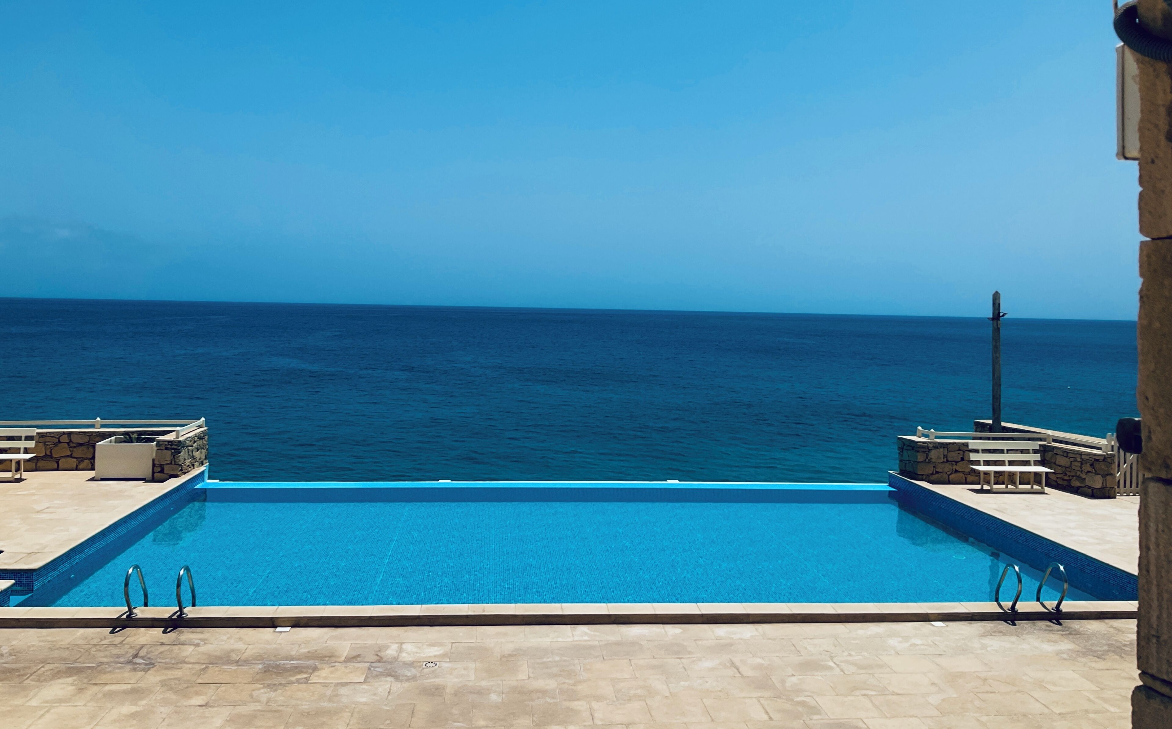 A swimming pool with a view of the ocean.
