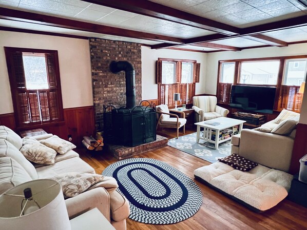 A cozy living room with a fireplace, comfortable seating, and a television.