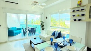 A bright, spacious living area with a dining table set for two, a sofa, and a ceiling fan. - Caribbean Retreat, apartment 304 (Cartagena)