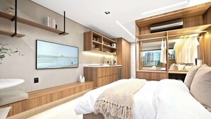 Un dormitorio moderno con una cama grande, un tocador empotrado, un televisor y un armario con espejo.