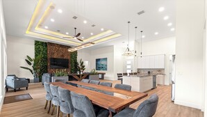 A modern kitchen with white cabinets, a built-in oven, and a stainless steel refrigerator. - Float, Relax, Repeat - Brand New 6 BR, 4.5 BA Waterfront Home On Rainbow River (Dunnellon)