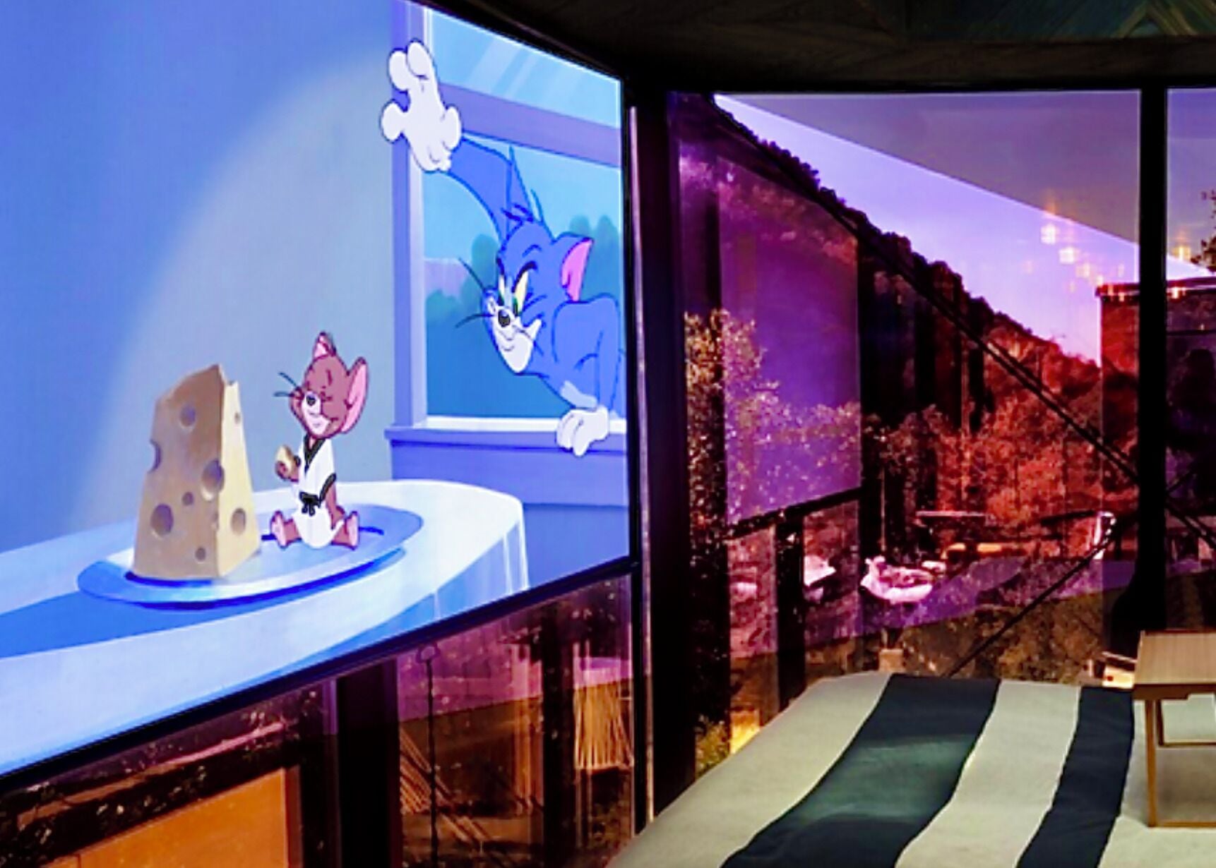 A cartoon character on a table with a window in the background.