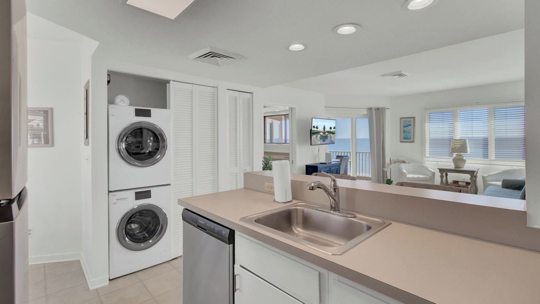 A modern kitchen with a dishwasher, a sink, and a built-in washing machine.
