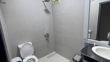 Separate bathtub and shower, towels, soap, shampoo