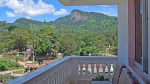A balcony with a view of a mountainous landscape.
