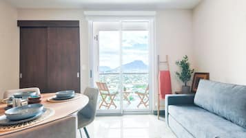 Business Suite, Balcony, City View | Living area | 50-inch Smart TV with cable channels, TV, streaming services