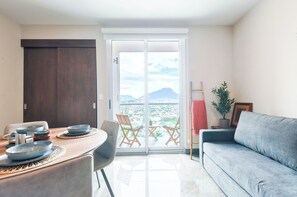 Business Suite, Balcony, City View | Living area | 50-inch Smart TV with cable channels, TV, streaming services