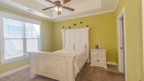 A bedroom with a bed, a nightstand, a ceiling fan, and a window with blinds. - Perfect Masters Week Stay- Spacious Home ONLY 10 Miles from Augusta National (North Augusta)
