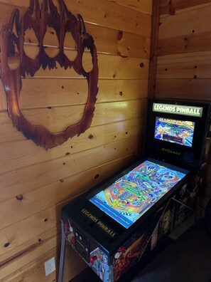 A pinball machine titled 'Legends Pinball' with a colorful playfield and a wooden wall backdrop. - 6 BR, large indoor pool, full arcade, views, cinema, and gameroom. Sleeps 25+ (Pittman Center)