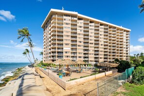 A beachfront hotel with multiple balconies, a pool area, and a view of the ocean. - SUMMER SALE! Cozy studio with ocean views and premium amenities - RK 1103 (Lahaina)