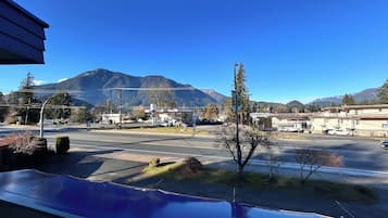 A mountain view with a gas station and buildings in the foreground.