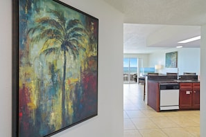 A modern kitchen with a large island, a dining area, and a view of the outdoors. - True Beachfront Destin Condo | Ground Floor | Sleeps 6 | Crystal Beach (Destin)