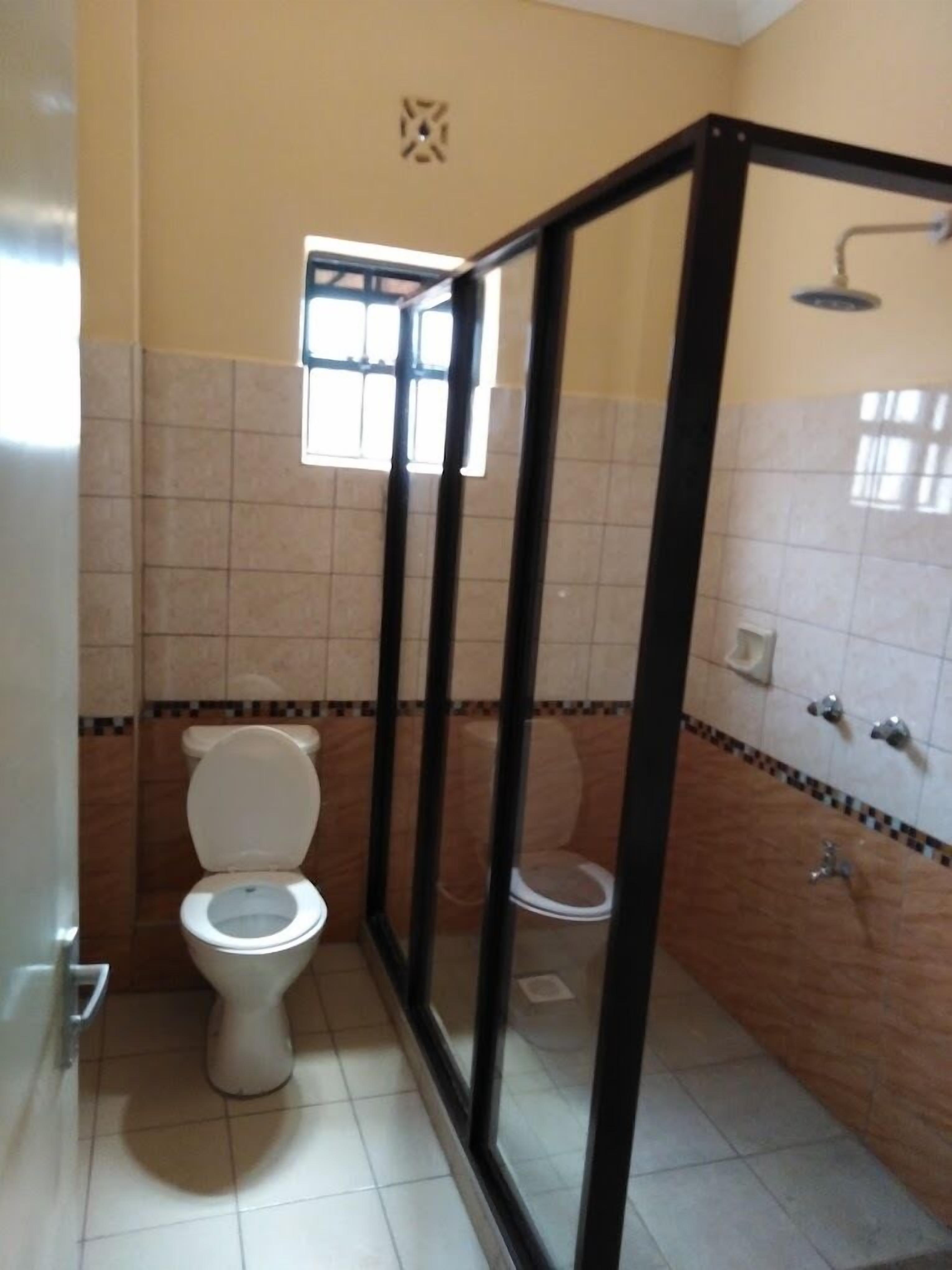 Standard Double Room | Bathroom | Shower, slippers, towels, soap