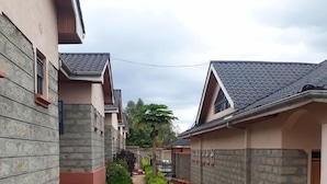 A narrow pathway flanked by two-story buildings with stone facades and tiled roofs. - Alem Resort Tawa (Tawa)
