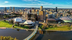 A cityscape with a prominent bridge, modern buildings, and a stadium. - KozyGuru | Joslin | Private Self-Contained 1 BR (Joslin)