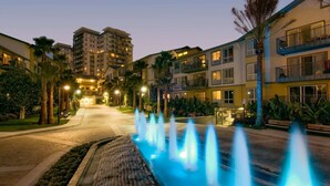 A hotel with multiple floors, a central courtyard with a water feature, and well-lit balconies. - Blue Horizon' 3BD 2BA Full Ocean Views Panoramic Heaven Venice Beach (Marina del Rey)