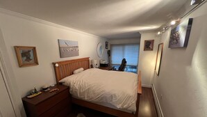 A bedroom with a bed, a nightstand, a dresser, and a rug. - Perfectly located Extra large 1-bedroom condo in central Aspen (Aspen)